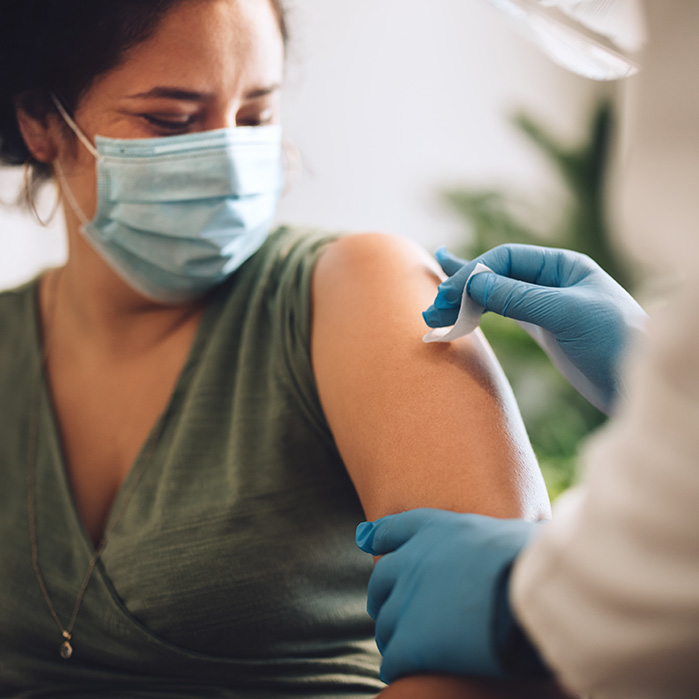 Doctor Preparing a Woman for a Vaccination Doctor Preparing a Woman for a Vaccination