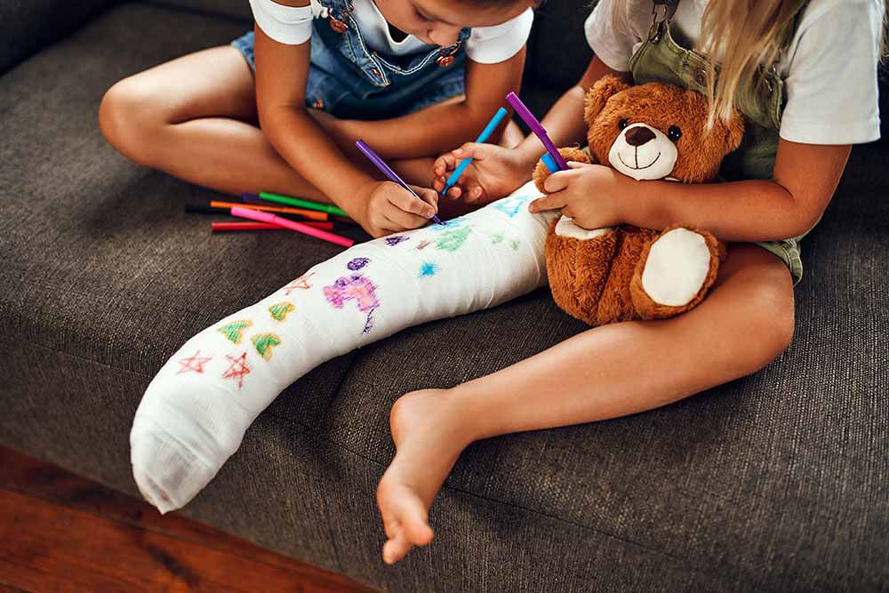 Girl signing another girls leg cast
