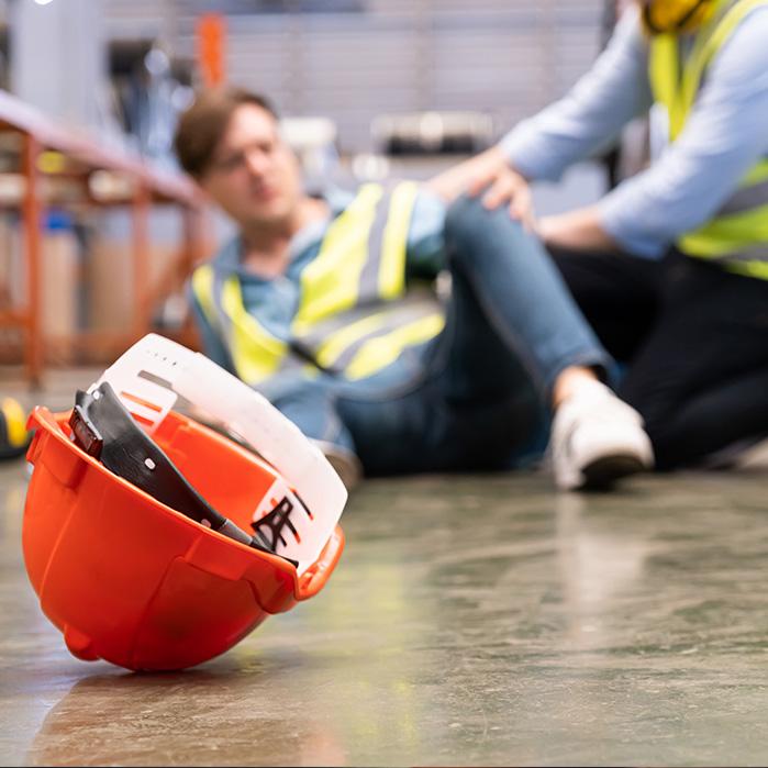 Injured Employee with Hard Hat in the Foreground Injured Employee with Hard Hat in the Foreground