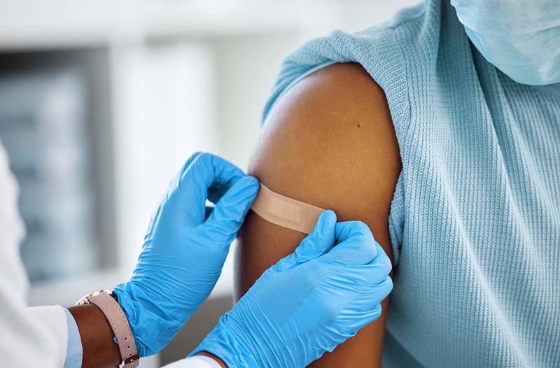 Person Getting a Bandaid over a Shot Person Getting a Bandaid over a Shot