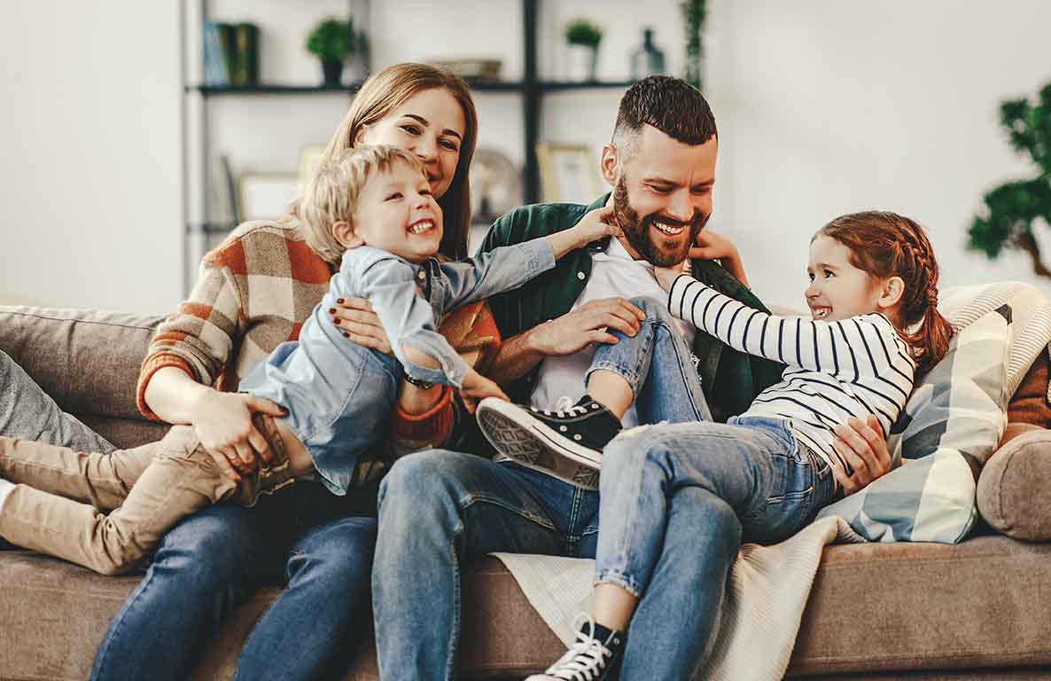 happy family playing together on the couch happy family playing together on the couch