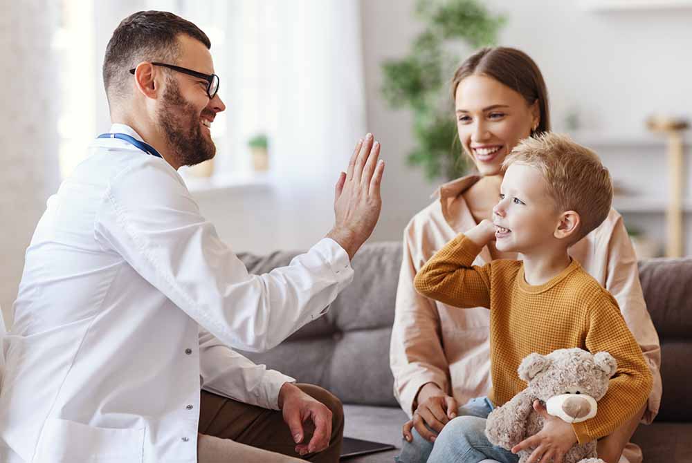 Hero-Image family doctor pediatrician conducts examination of child boy who came with his mother, an